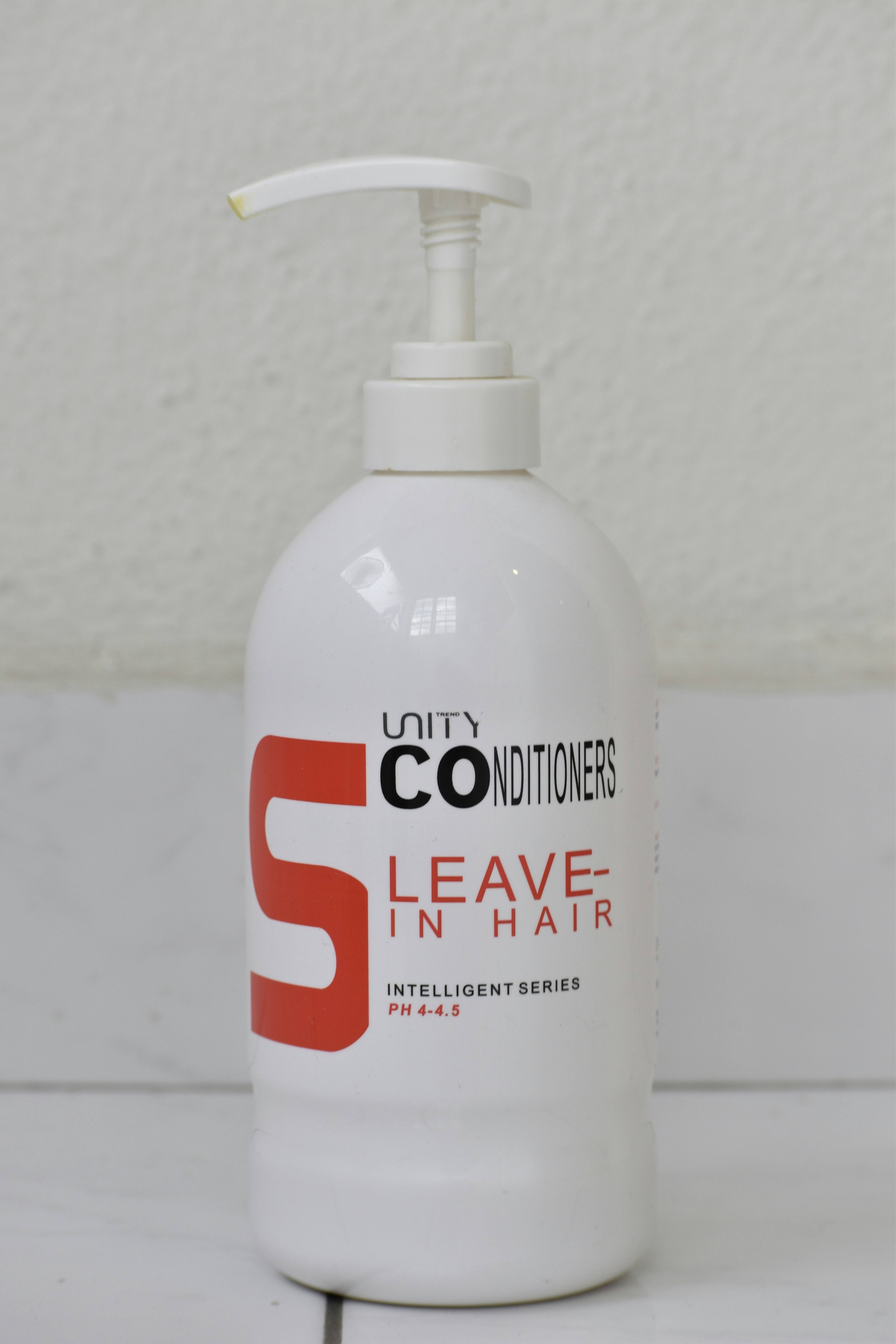 White spray bottle of leave-in conditioner for natural hair maintenance