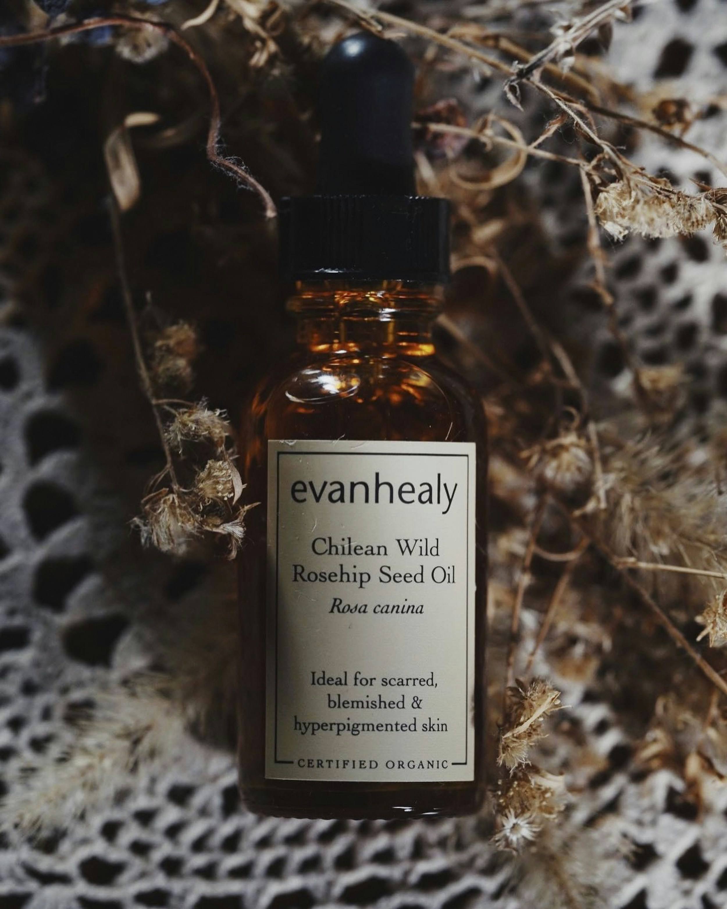 Amber glass bottle of natural hair oil with botanical ingredients